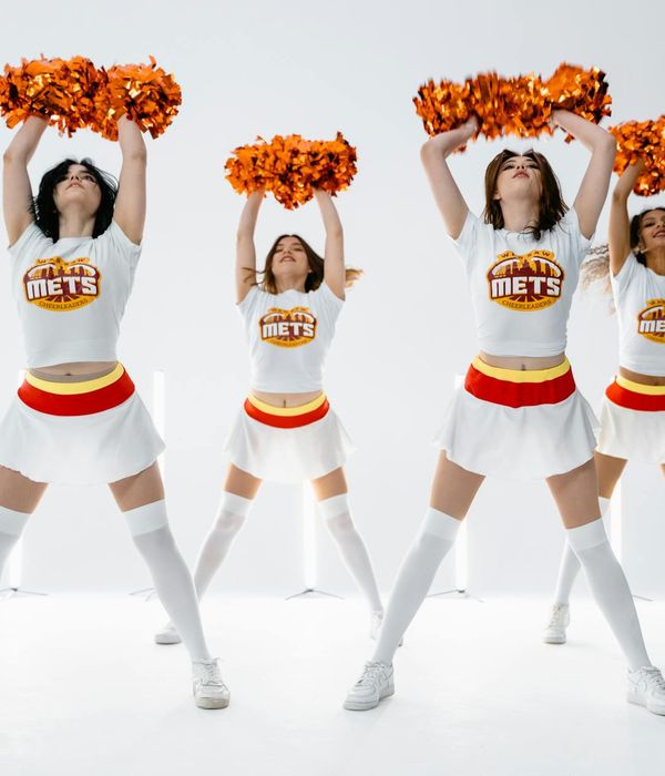 Woman performing a gentle, flowing cardio movement in a bright studio.